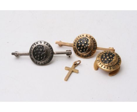 A gold stick brooch, gold crucifix, cufflink and another stick brooch.