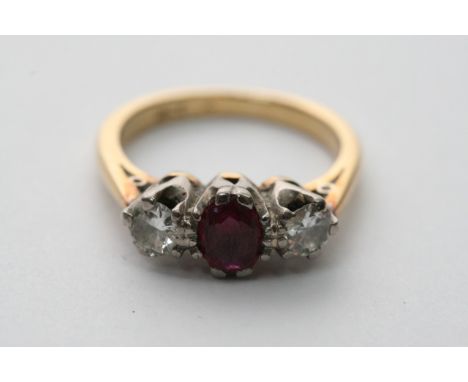 An 18ct gold ring set with two diamonds and a ruby, approx 3.8g and size between H and I.