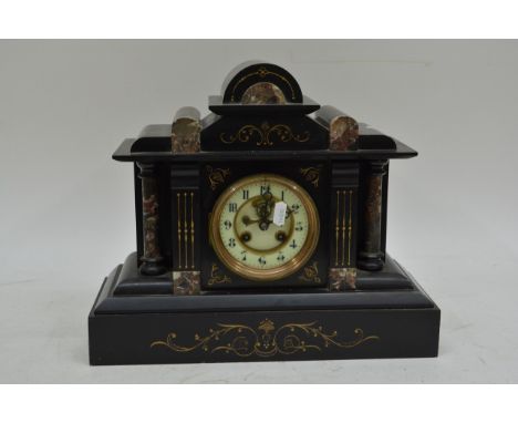A Victorian black slate mantel clock, fitted with a French movement striking on a gong 