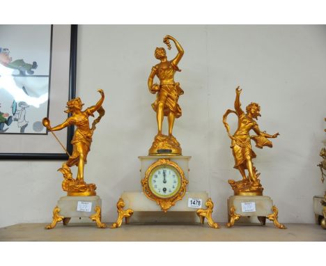 A 19th Century French gilt garniture the clock surmounted with an Art Noveau maiden the onyx case with Arabic numerasl