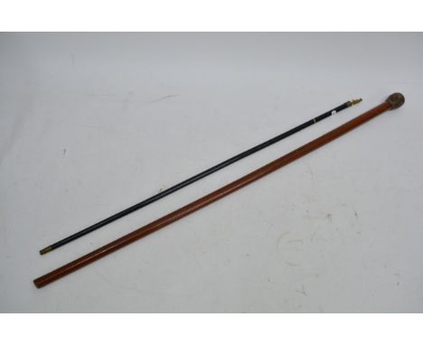 A swagger stick with Napoleonic soldier finial and one other walking stick (2).