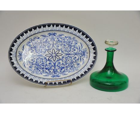 A green glass ship's decanter and a blue and white ceramic oval platter (2).