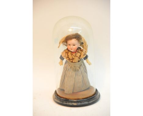 A German Walther & Sohn bisque headed doll with crown mark under a glass dome
