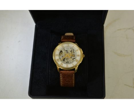 A gents Rotary automatic skeleton wristwatch of gold tone design and roman numerals, set on a brown leather strap