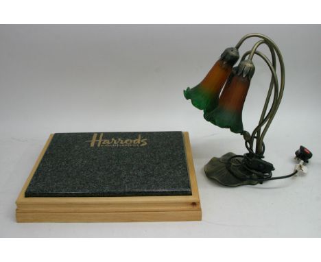 A granite and wood chopping board attribute to Harrods Knightsbridge alongside a modern lamp in the shape of three flowers
