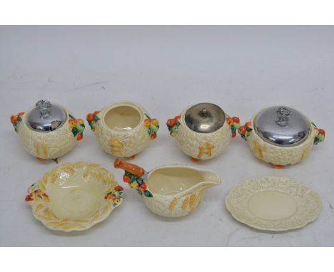 A collection of 5 Clarice Cliff harvest pattern preserve pots
