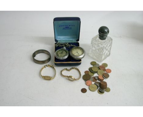 A silver topped scent bottle, a silver bangle, two gold tone wristwatches, a small bag of coins and two pocket watches