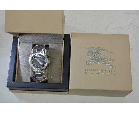 A boxed as new Burberry large gents sports chronograph wristwatch with three subsidiary dials and date aperture set on a stai