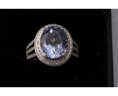 A 14K white gold and diamond ring set with an oval cut tanzanite approx 5.80 ct diamonds approx 1ct weight