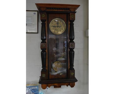 A Vienna type continental,walnut cased wall clock with visible pendulum and weights. 