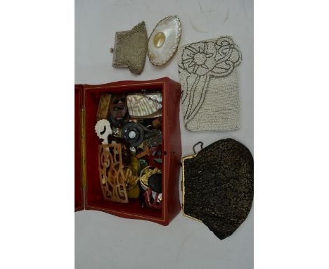 A box of costume jewellery including beaded purses, Art Deco stick pin etc.