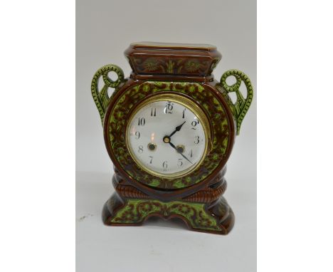 A green glazed pottery mantle clock