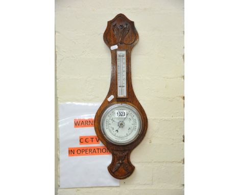 An oak cased mercury filled banjo barometer.
