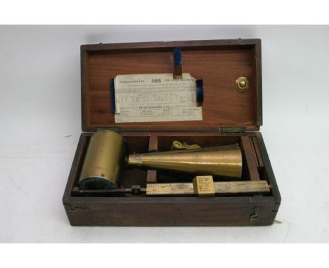 A wooden cased brass Chondrometer or corn balance scale made by Bryan Corcoran, the inside lid bearing original paper label.A