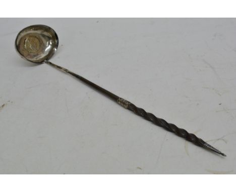 A silver toddy ladle, the bowl inset with a Georgian coin.