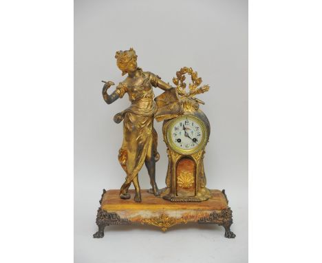 An Astra gilt metal figural mantle clock with floral decorated enamel dial, on onyx base.Approximately 44cm high