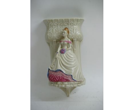 A Clarice Cliff wall pocket with a raised Art Deco maiden