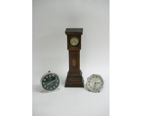 A circular clock in an inlaid case in the form of a longcase clock, approx 33.5cm plus two vintage alarm clocks (3).