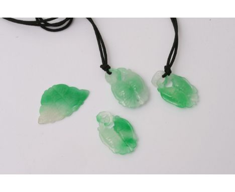 Four jade pendants comprising of a butterfly shaped pendant and three pairs of fish