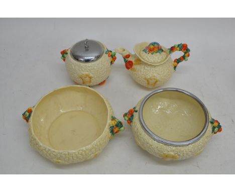 A collection of Clarice Cliff harvest pattern ceramics, comprising two bowls, a biscuit barrel, and a tea pot 