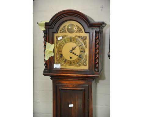 An oak longcase clock with barley twist supports fitted with a three train movement, height 165cm 