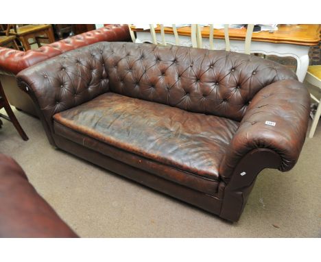 A brown leather button back Chesterfield sofa, approx 177cm x 89cm x 67cm.