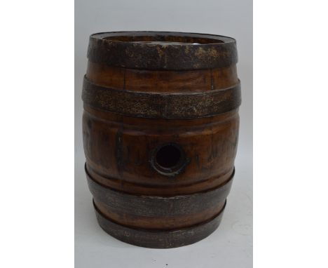 A walking stick stand in the form of a barrel.