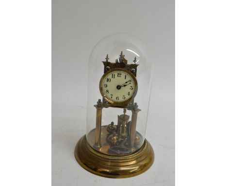 A brass two pillar anniversary clock under a glass dome