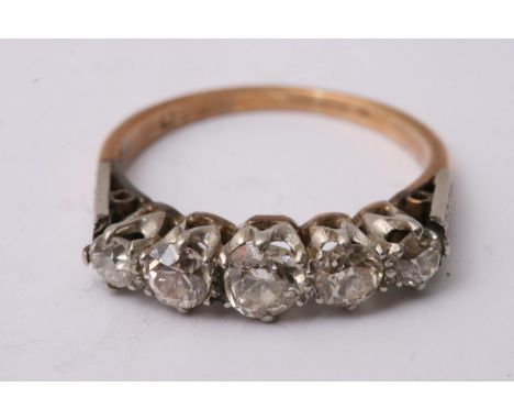 A 9ct gold ring inset with a row of five diamonds, approximate ring size L