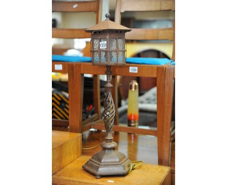 An Arts and Crafts cast iron table lamp.