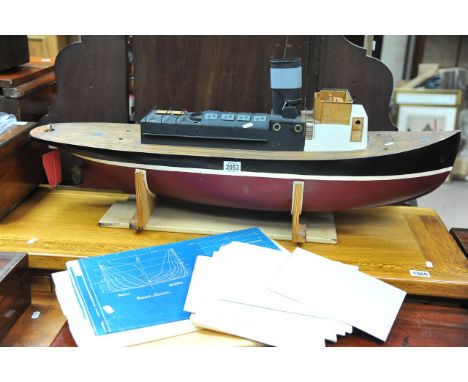 A scale built model of a single funnel boat sold with blue print plans and other plans.