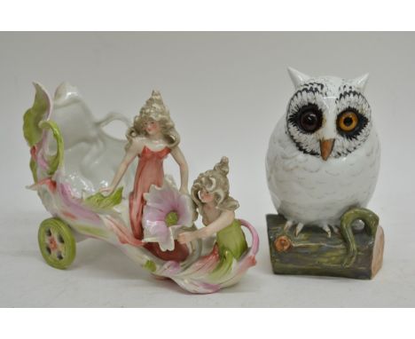 A French ceramic owl with glass eyes and a Continental porcelain chariot decorated with two female figures (2).