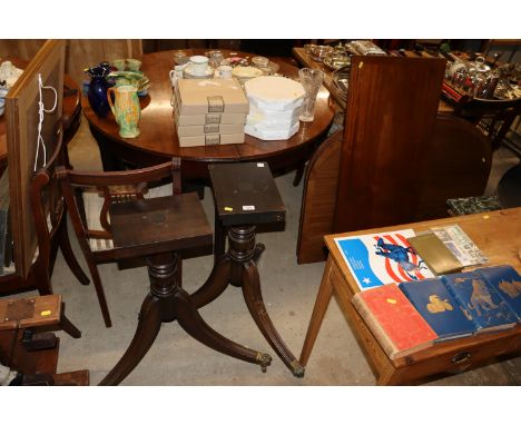 A reproduction mahogany twin pillar dining table with extra leaf; and a set of four reproduction mahogany lyre back dining ch