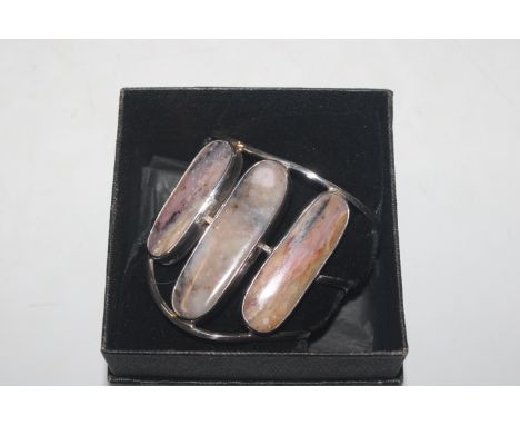 A silver and polished stone bangle