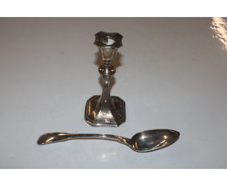 A silver candlestick with filled base; and a white metal spoon approx. 123gms