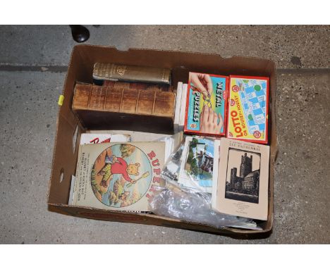 A box of miscellaneous vintage puzzles, books, Rupert magazine etc.