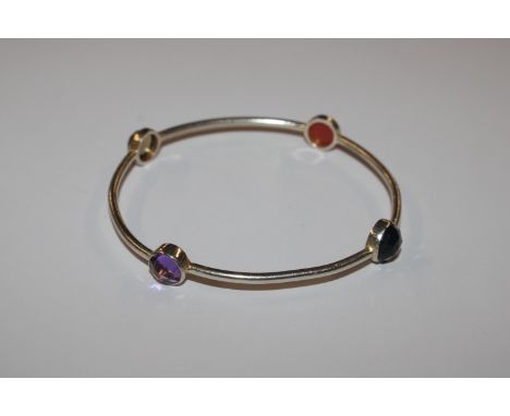 A silver and gem set bangle 