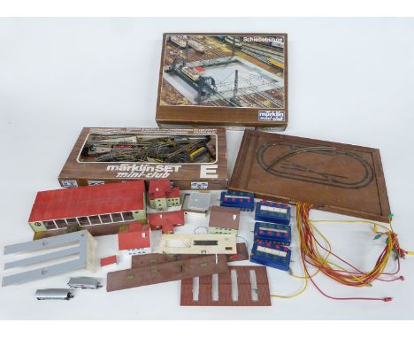 A collection of Marklin and similar Z gauge locomotives, rolling stock, buildings, track and accessories including Mini-Club 