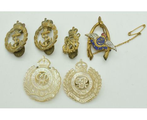 Two mother of pearl Royal Engineers brooches and three Royal Navy badges