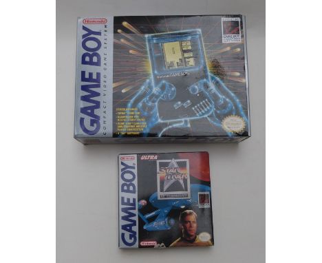 Nintendo Game Boy hand held video games console, in original box together with three games Star Trek 25th Anniversary, Caesar