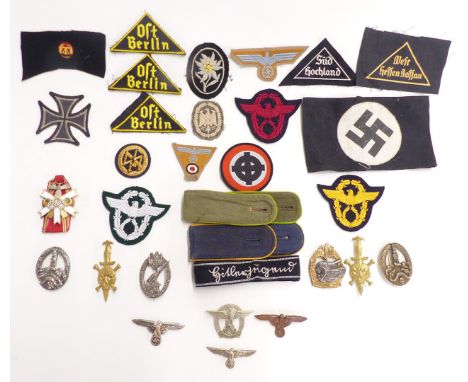 Replica Nazi German badges and insignia to include armband, enamel Olympic pendant, SS dagger badges, Panzer 200 engagements 