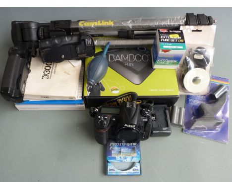 Nikon D300 DSLR camera body in original box with two battery holder bases, charger, accessories including a tripod, Kenko Nik