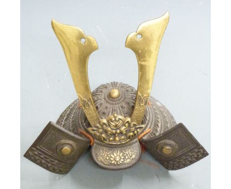 Japanese cast iron Samurai helmet with large brass maedate and embossed decoration, 23cm tall.&nbsp;