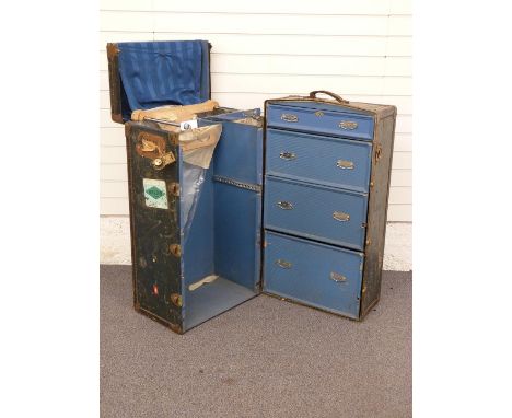 A vintage metal-bound 'WataJoy' travelling wardrobe with fitted interior and shipping labels, W61 x D57 x H103xm