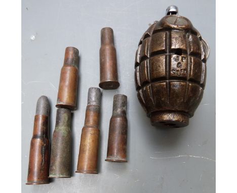 An innert 'Mills Bomb' hand grenade marked to the base 'No. 36 M II' converted into a table lighter together with six used br