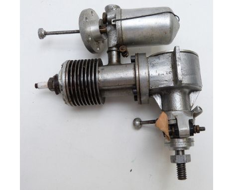 Vintage spark ignition model aircraft pretol engine with fabricated steel cylinder, together with spare unfinned cylinder hea