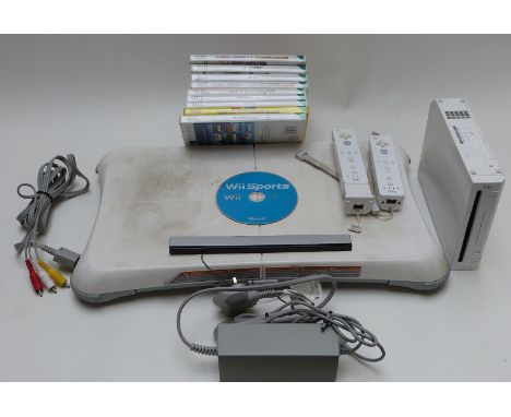 Nintendo Wii video games console together with a Wii Fit board and eight games.&nbsp;