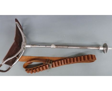 A vintage shooting stick together with a brown leather 12 bore shotgun cartridge belt and a wooden priest.&nbsp;