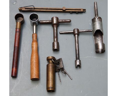 Seven shooting/ reloading tools comprising a brass spring loaded percussion cap dispenser, two nipple keys, three powder meas