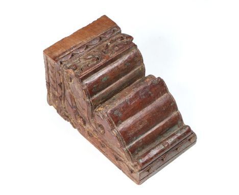 An Indo-Persian  carved hardwood bracket with traces of original paint and gilt decoration, 24cms wide.